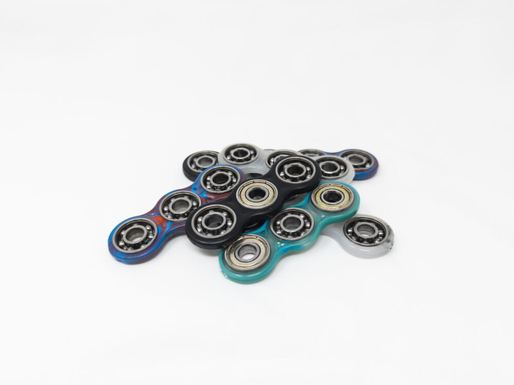 pile of 7 fidget spinners in different colors